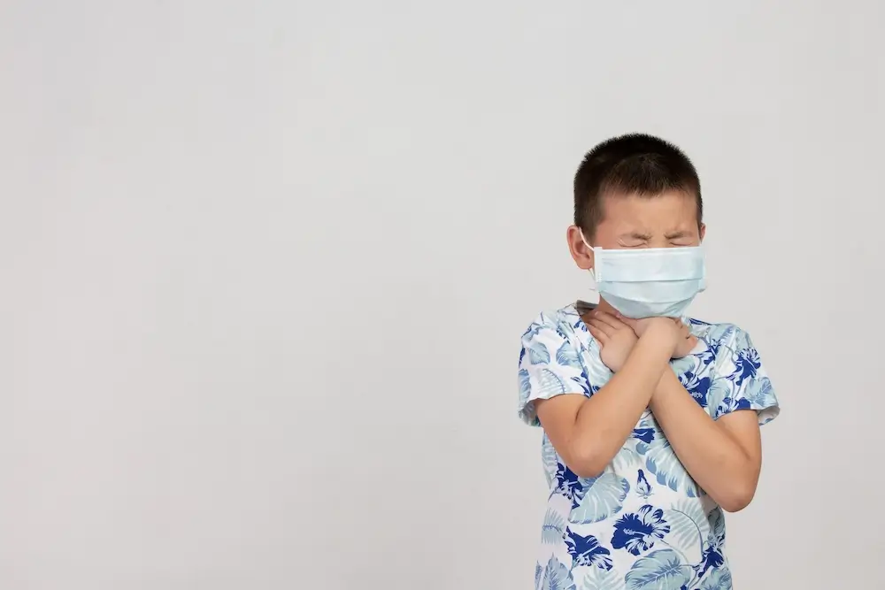 boy-with-mask-posing-white-background.webp